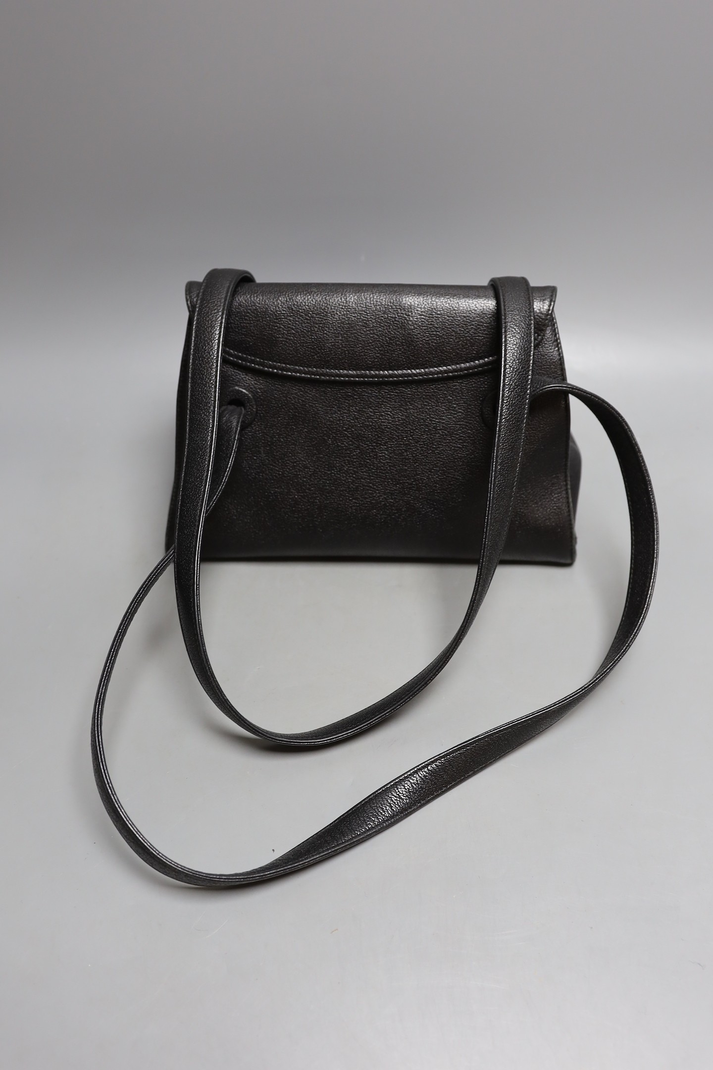 A black Chanel shoulder bag with two straps and Chanel logo lock